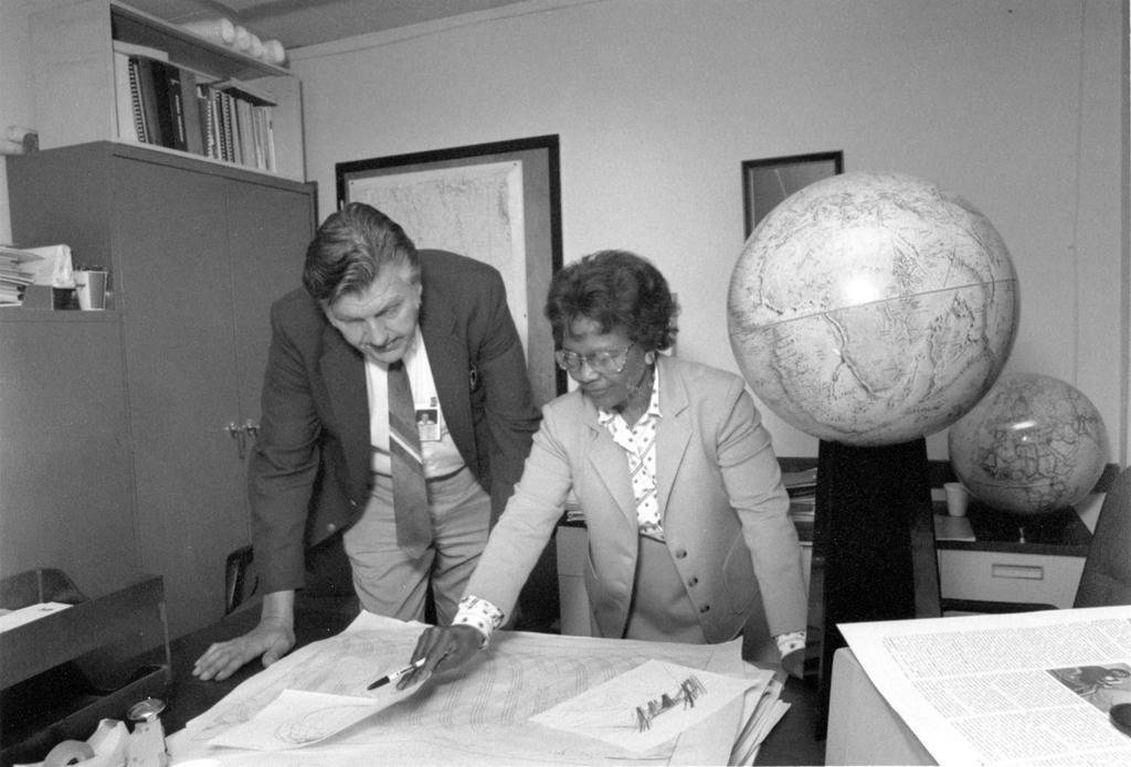 Gladys West and Sam Smith look over data from the Global Positioning System at Dahlgren in 1985....