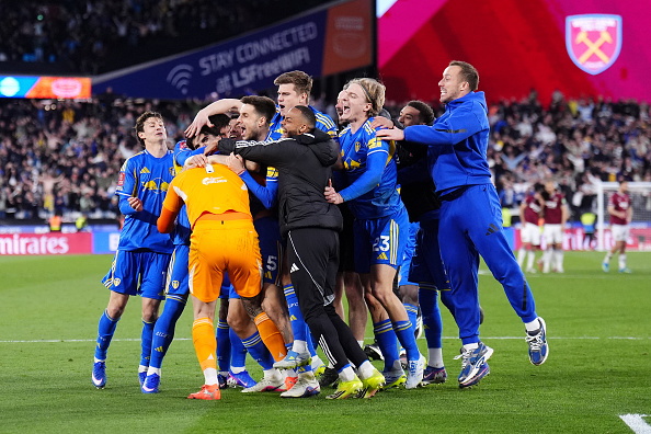 Leeds United goalkeeper Lucas Perri (centre left) celebrates with team-mates after winning the...
