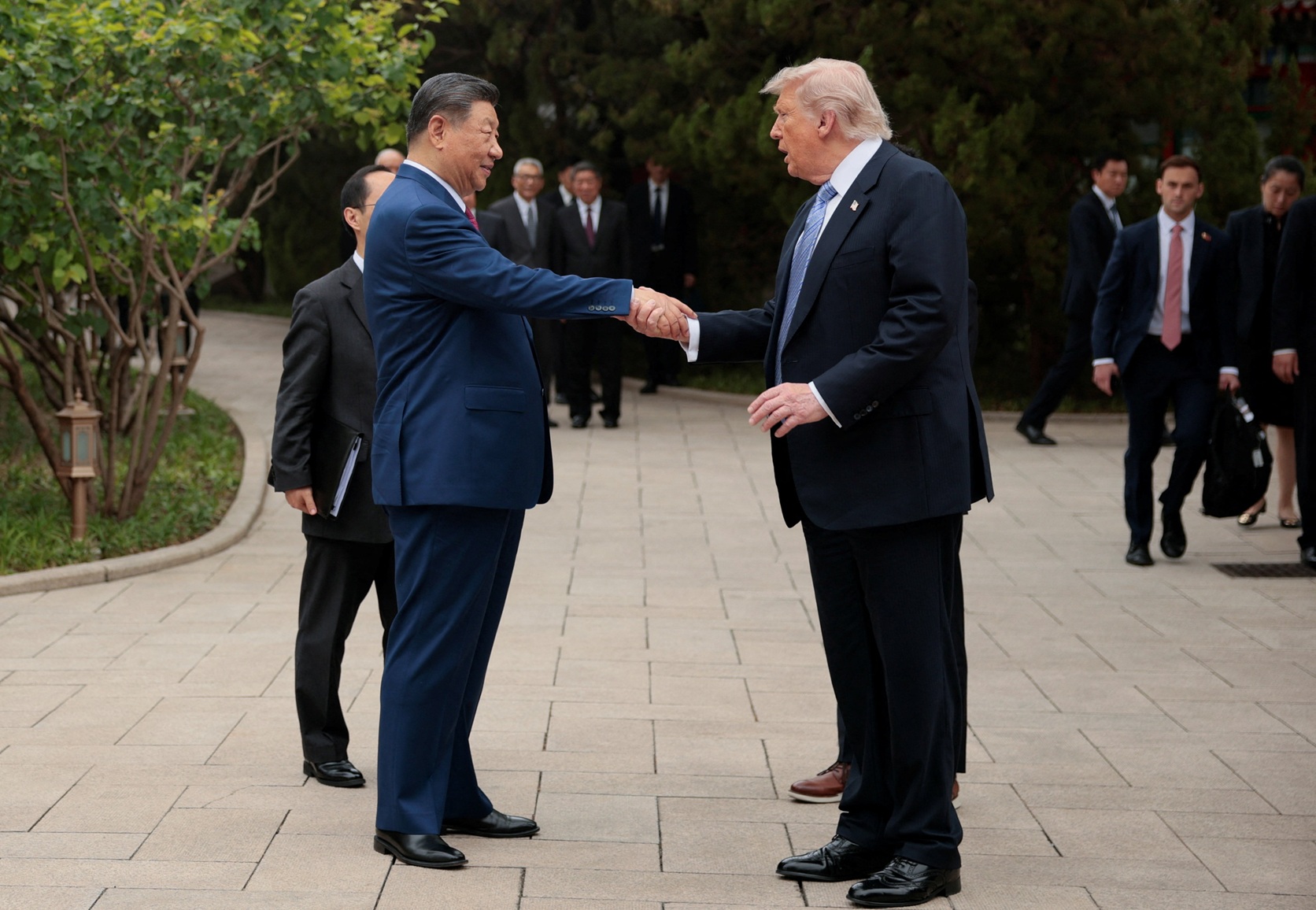 Chinese President Xi Jinping shakes hands with US President Donald Trump after a visit to the...