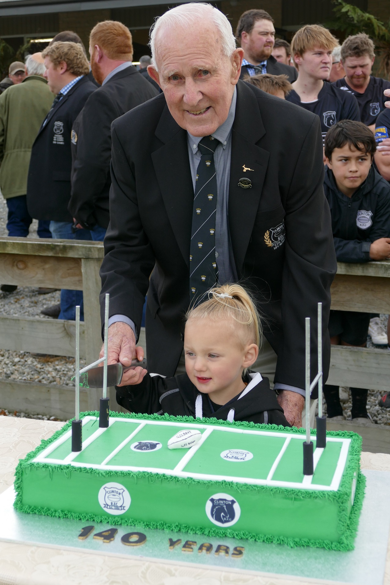 Longest-serving life member Peter Miller, 90, and youngest current member Lottie Timms, 3, cut...