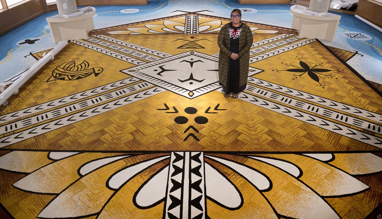 Artist Ana Teofilo with the carpet she designed for the Tangata Moana gallery at the Otago Museum.