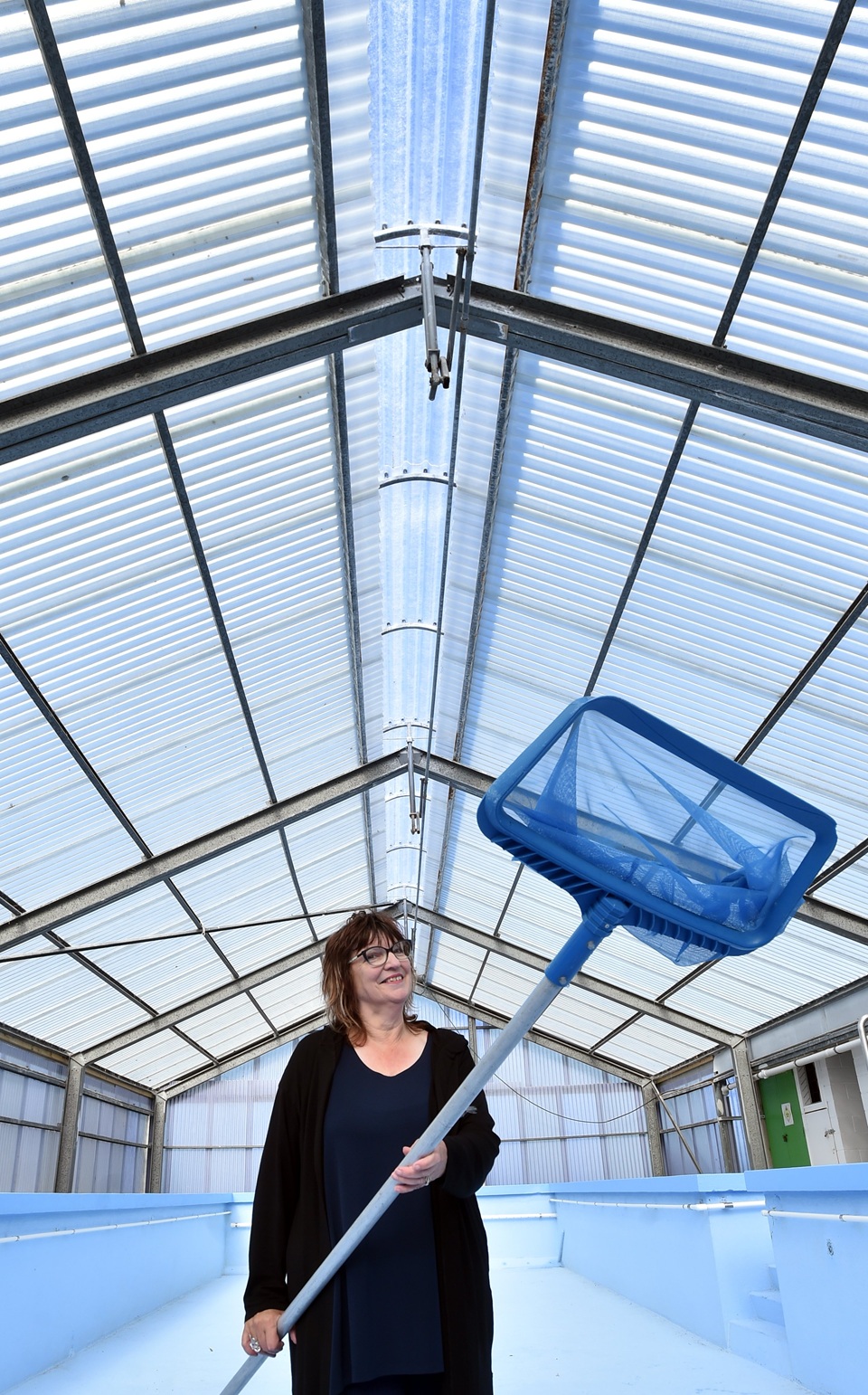 Ravensbourne Primary School principal Jo Wilson admires the new roof vent in the Ravensbourne...