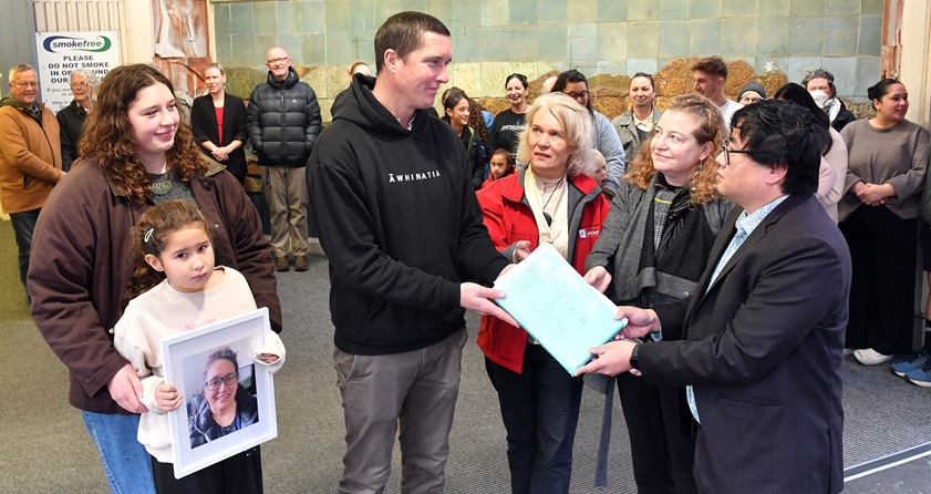 Sam Weepers, of Dunedin, hands over a petition to (from left) Labour MPs Ingrid Leary and Rachel...