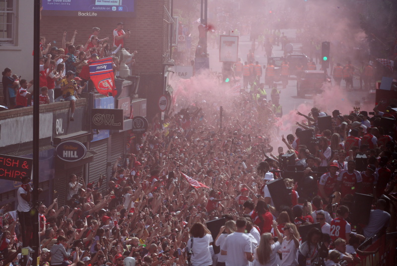 Arsenal fans line the streets to celebrate during the victory parade for the team's Premier...