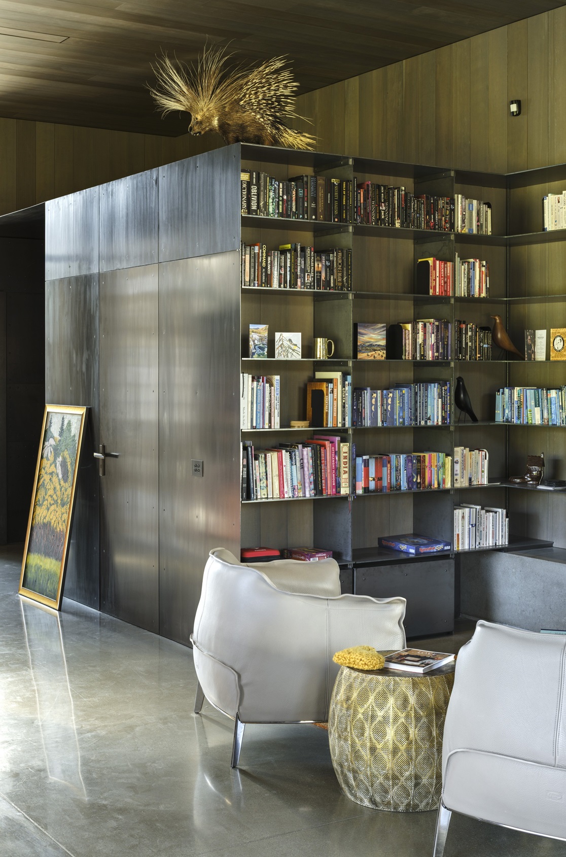 A feature of the living space is a beautifully crafted steel bookcase for displaying favourite...