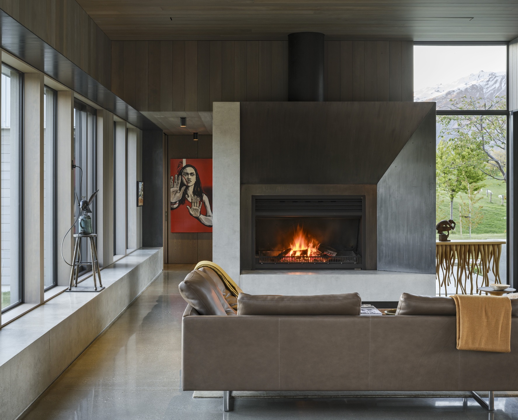 With a fireplace at its centre, the living room opens both north and south to capture every mood....