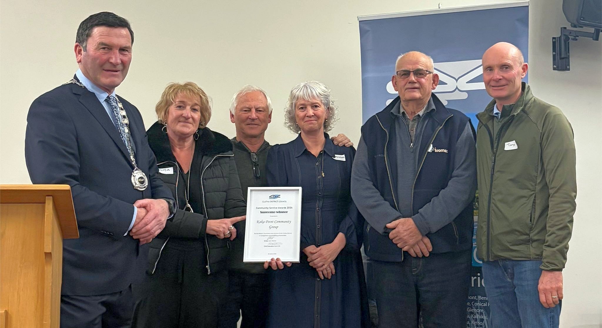 Displaying the supreme winner award are (from left) Mayor Jock Martin and Kaka Point Community...