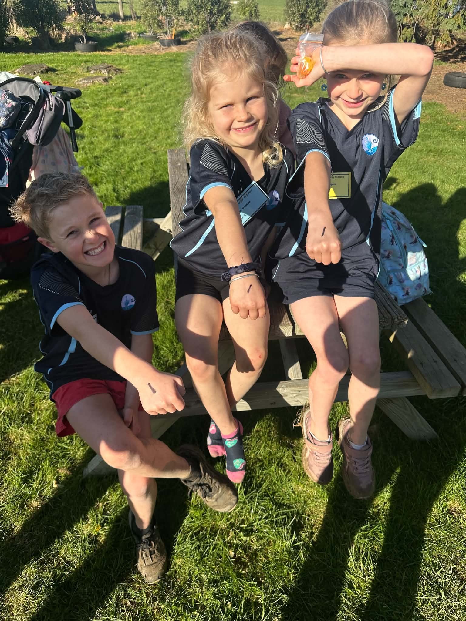 A sharpie number ‘‘1’’ on each of the McKenzie children's hands (from left) Clay, Harper, and...