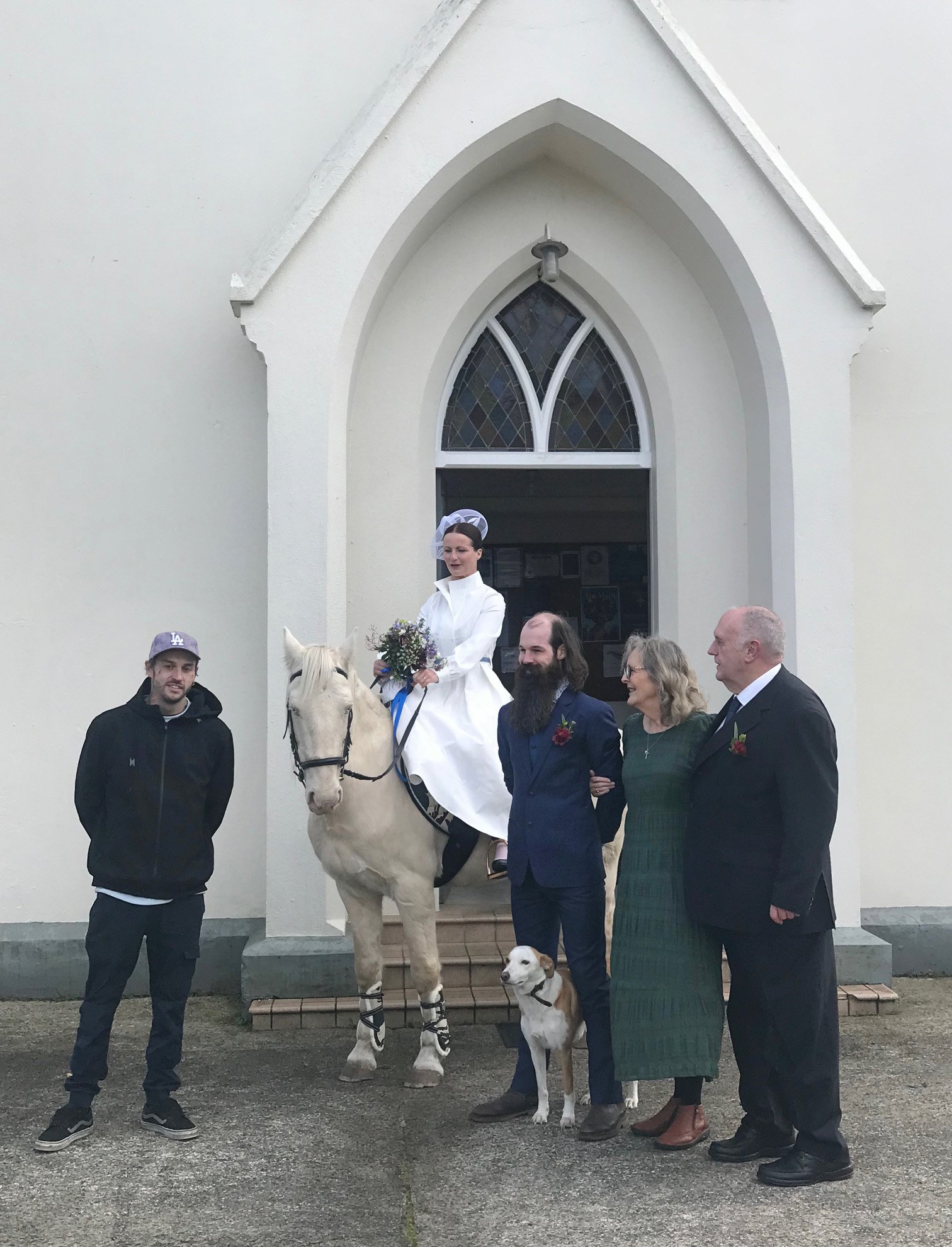 Bride Courtney Henry, on her horse Denver, with husband Reuben Henry and godparents
...