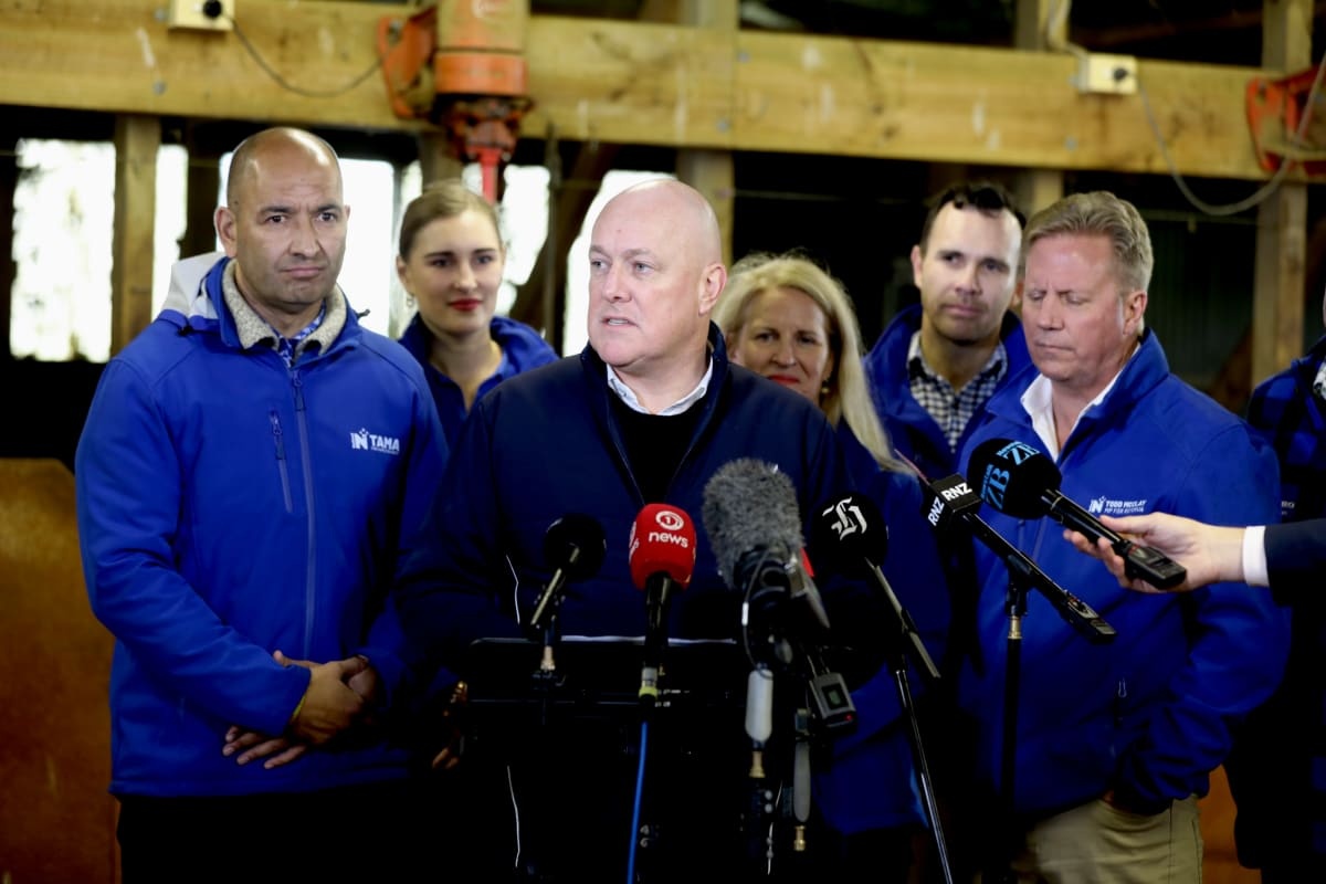 National Party leader Christopher Luxon (centre) made the announcement today at a farm today....