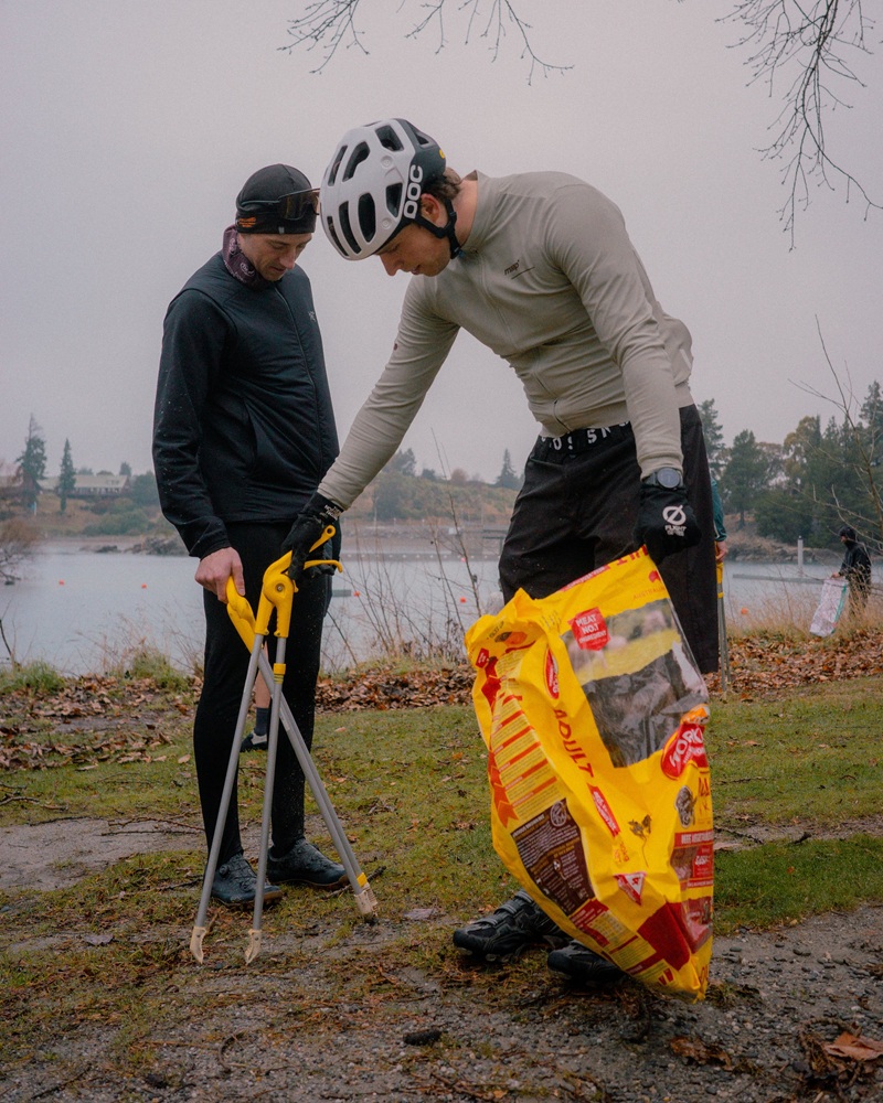 Cyclists pick up litter on the shore near the Lake Hāwea boat ramp as part of a collaboration...