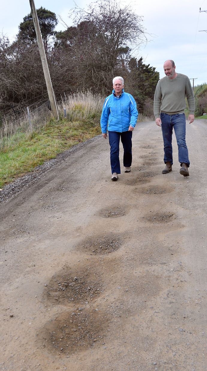 McMaster Rd residents Julie Pearse and Dr Ohad Dar would like to see the troublesome road sealed....
