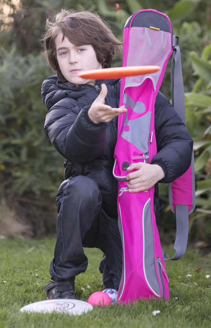 Dunedin resident Janosch Kwak, 9, tries out his new frisbees and hockey stick he picked out at...