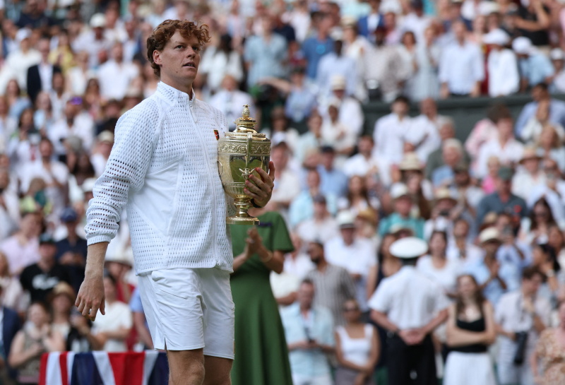 Jan Skinner holds the trophy after claiming the Wimbledon title this morning. Photo: Reuters