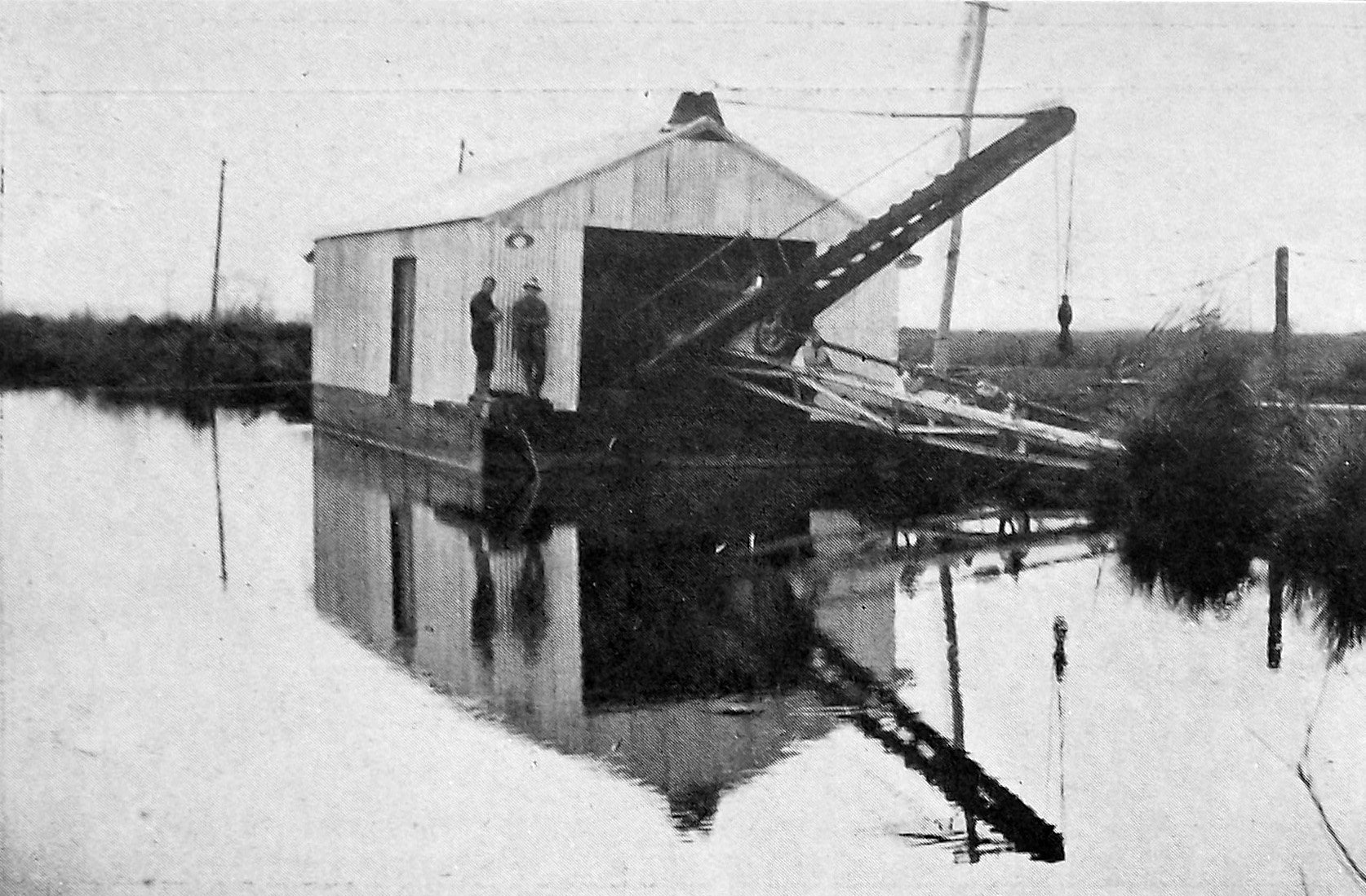 A 100-horsepower electric suction dredge ready to start in the Waipori River on the Taieri Plain...