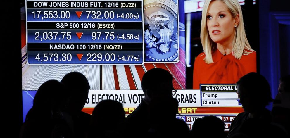 Trump supporters watch financial reaction to the US election results at Donald Trump's election...