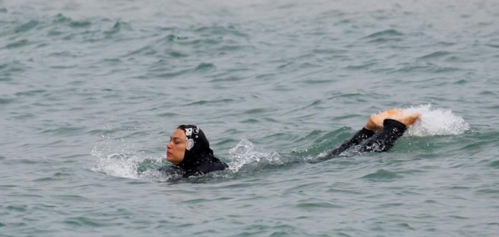 A Muslim woman wearing a burkini that leaves only the face, hands and feet exposed at a beach in Marseille earlier this month. Photo: Reuters