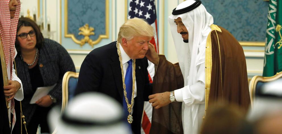 King Salman bin Abdulaziz Al Saud  (right) presents Donald Trump with the Collar of Abdulaziz Al...