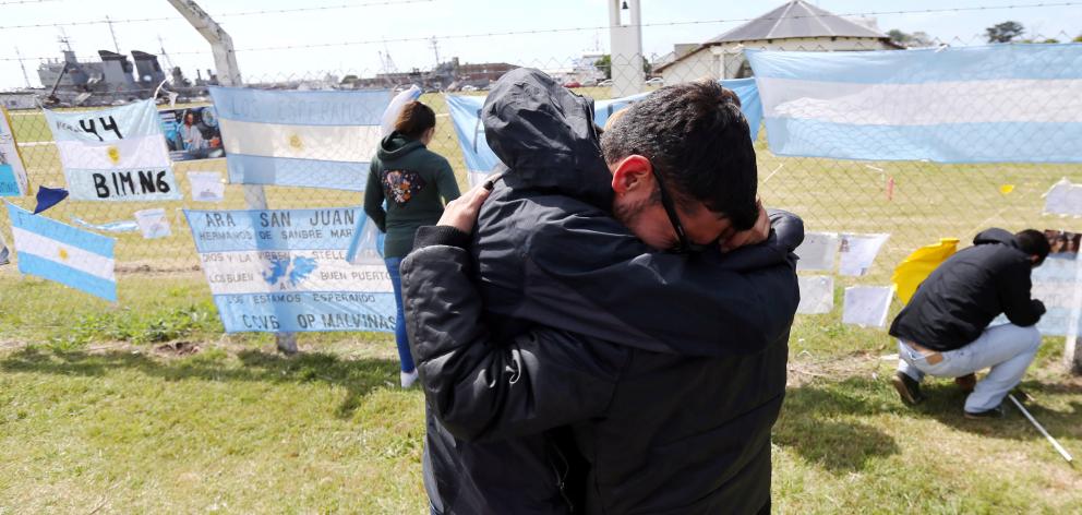 Relatives and friends of Alejandro Tagliapietra, one of the 44 crew missing, comfort each other at the naval base in Mar del Plata. Photo: Reuters 