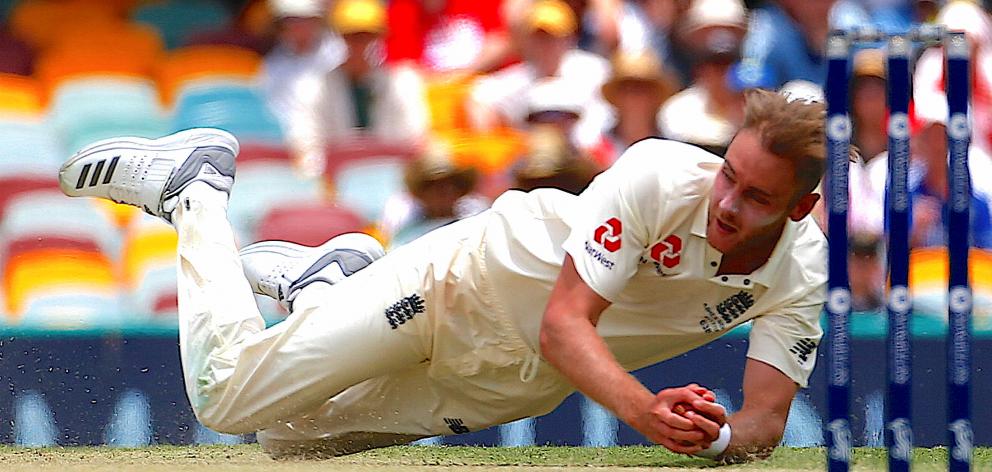 England's Stuart Broad takes a catch to dismiss Australia's Mitchell Starc during the third day...