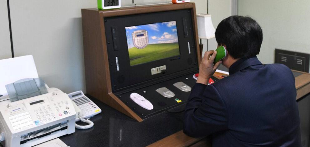 A South Korean government official checks the direct communications hotline. Photo: Reuters 