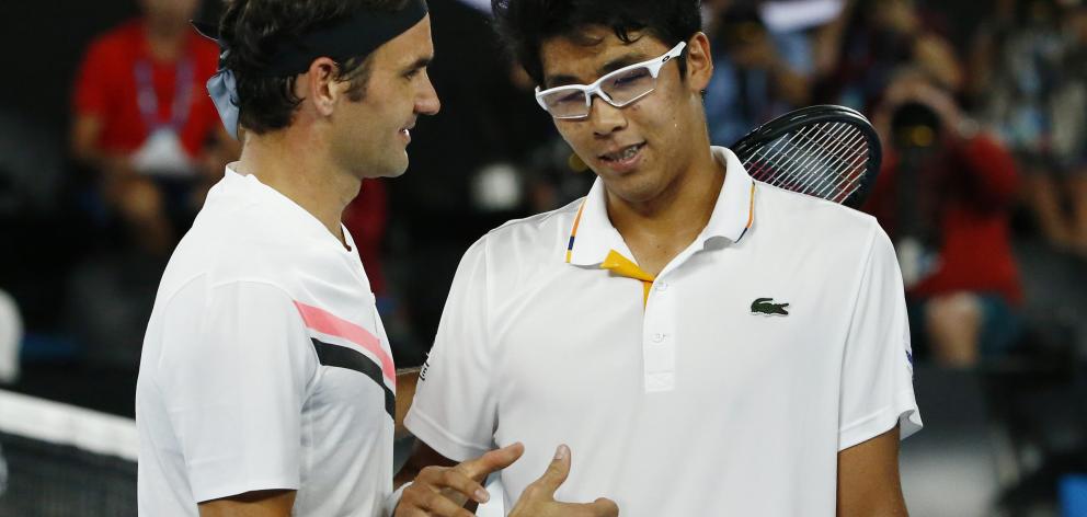 Roger Federer with Chung Hyeon, who retired from the match due to injury. Photo: Reuters 