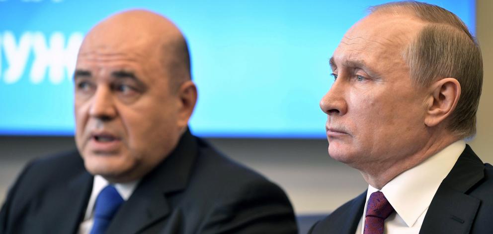 Vladimir Putin (right) with Mikhail Mishustin. Photo: Sputnik/Kremlin via Reuters 