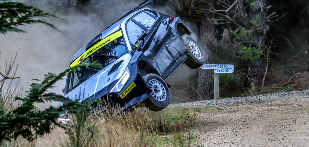 Indian rally driver Gaurav Gill and his co-driver hold on for dear life as their car leaves the ...