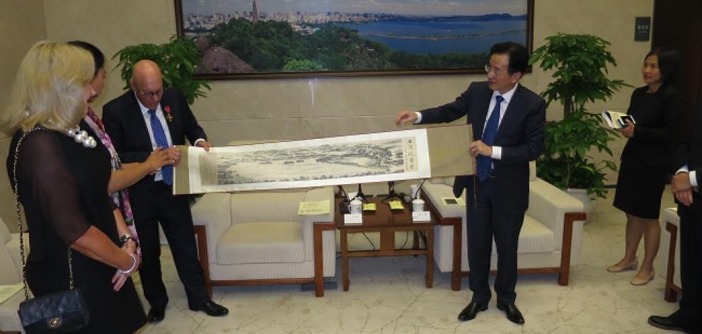 Mayor Jim Boult accepts a gift from Hangzhou vice mayor Chen Weiqiang on behalf of Queenstown. Photo: Mountain Scene