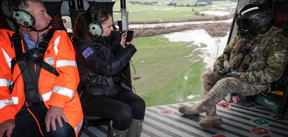 Ashburton Mayor Neil Brown, left, and Prime Minister Jacinda Ardern look at the damage caused by...