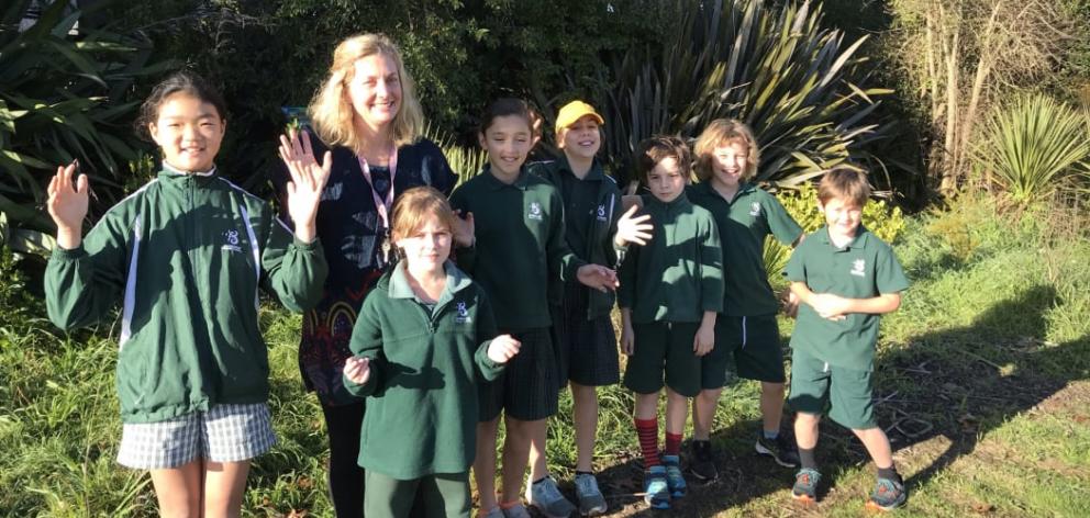 Bianca Woyak and students in Burnside Primary School's native garden area. Photo: RNZ