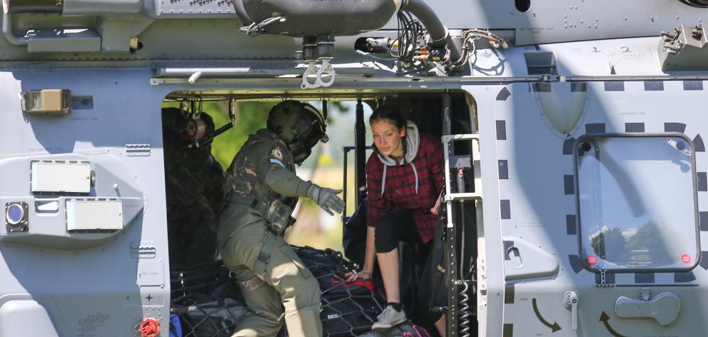 Military staff help tourists trapped by the Kaikoura earthquakes as they arrive by military...