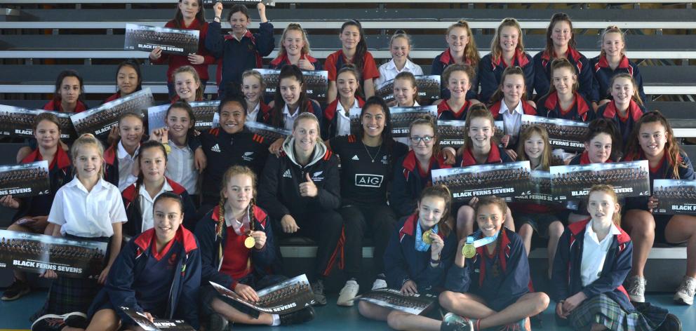 Black Ferns players Alena Saili, Kelly Brazier and Tenika Willison with a group of athletes from...
