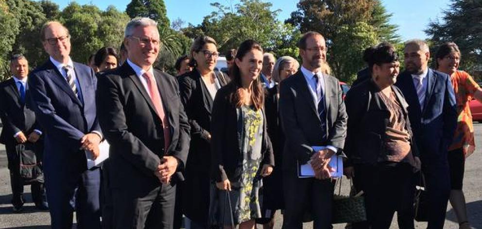 Prime Minister Jacinda Ardern arrives at Waitangi, flanked by minsters Kelvin Davis (front left),...