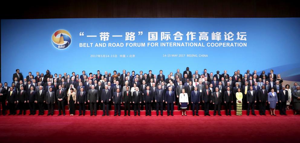 World leaders and delegates gather around China's president, Xi Jinping (front, centre) during...