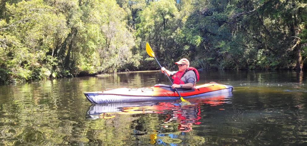 Mr Davies explores Canoe Cove on Lake Kaniere Westland in January.