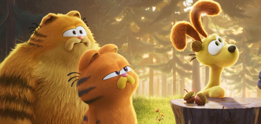 From left, Vic (voiced by Samuel L. Jackson), Garfield (Chris Pratt), and Odie (Harvey Guillén)....