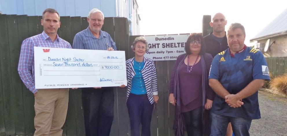 Goodman Fielder plant manager Gary Simmons (left) hands over a $7000 cheque from the firm’s annual golf  tournament to Dunedin Night Shelter Trust chairman Dave Brown (second from left) and trust secretary Pat Robertson (centre),  while members of the G