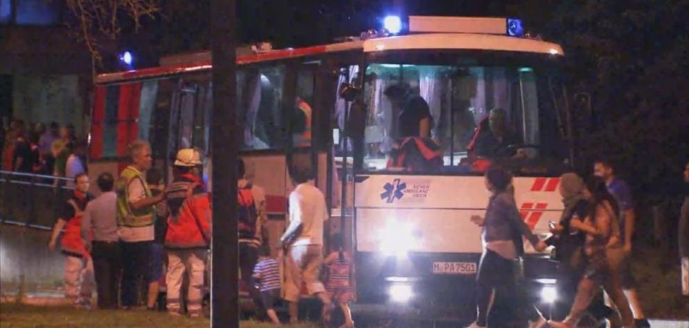 A screen grab taken from video footage shows people being evacuated onto a bus following a shooting rampage at the Olympia shopping mall in Munich, Germany. Photo from Reuters 