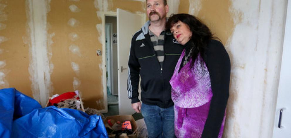 Karen and Scott Odell pose in their daughters' bedroom, which was contaminated by toxic paint during renovations in Whitby, Wellington. Photo / Hagen Hopkins