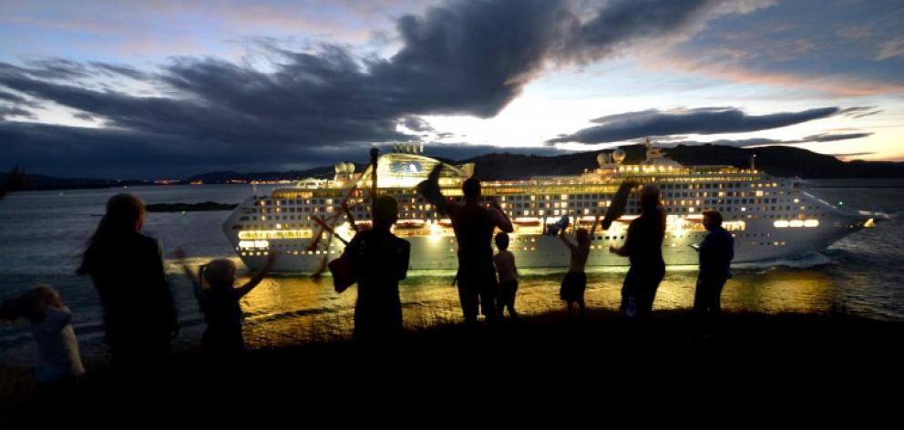 A fine Dunedin farewell . . . With bagpipes blaring and shirts waving the Scott and Wilden families farewell the cruise ship Dawn Princess at the gun emplacements near Taiaroa Head last night. Photo: Stephen Jaquiery