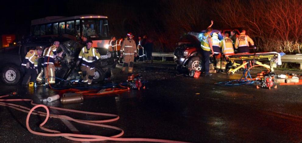 Emergency services work to free people trapped in two vehicles following a head-on smash on State Highway 1, just north of the Dunedin suburb of Pine Hill, last night. Photo by Peter McIntosh. 