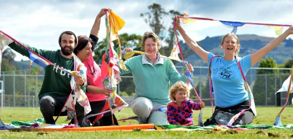 Waitati Music Festival organisers (from left) Thys van Scharen, Tania Turei, Lynda Peppercorn, Emily Peppercorn (3) and Katie Peppercorn play with some of the festival's decorations while setting up at Bland Park, in Waitati, yesterday. Photo by Peter McI