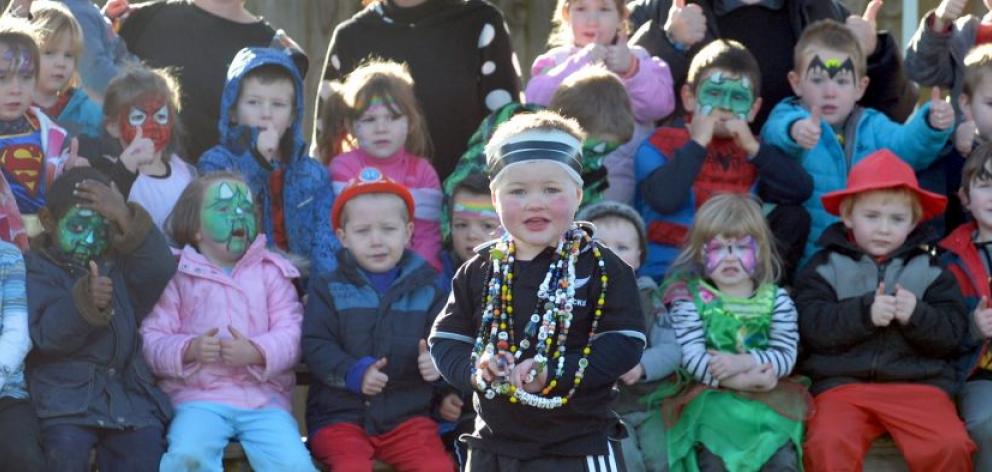 Xavier Michelle wears his ''beads of courage'', backed by playmates at Reid Park Kindergarten's dress-up fundraiser day yesterday. Photo by Peter McIntosh. 