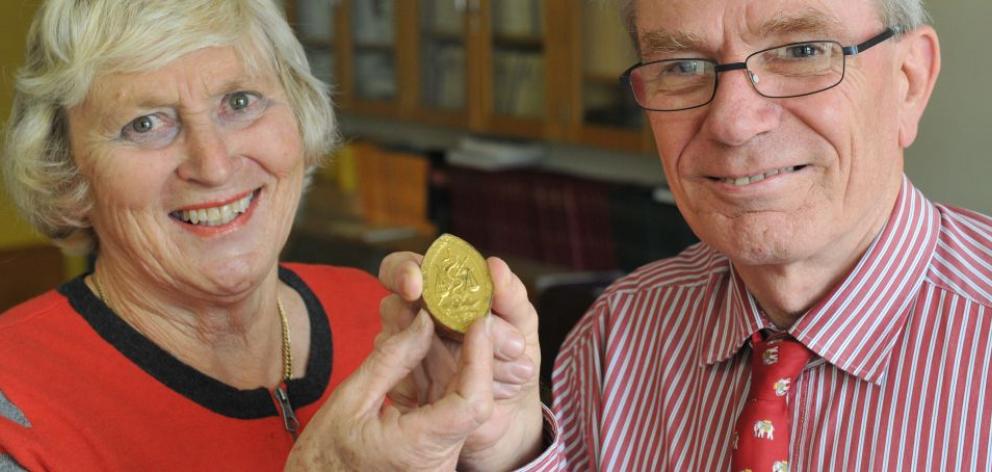 Jeanette Waters, of   Auckland, and Prof Jean-Claude Theis, of the University of Otago, hold   the  mystery medal. Photo by Craig Baxter.