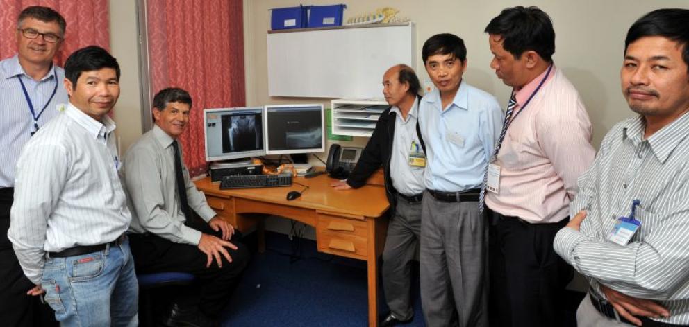 Taking a break from discussing clinical cases in Dunedin Hospital yesterday are (from left) Simon McMahon, Dr Doan Quang Phuong, John Dunbar, Dr Phan Canh Cuong, interpreter Phuoc Nguyen, Dr Nguyen Thuong Hung and Dr Dao Anh Tuan. Photo by Gregor Richards