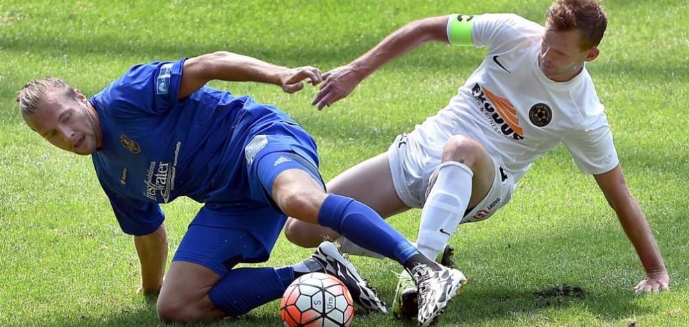 Southern United striker Sam French (left) challenges for the ball with Team Wellington captain Cole Peverley at Forsyth Barr Stadium yesterday. Photo by Peter McIntosh.