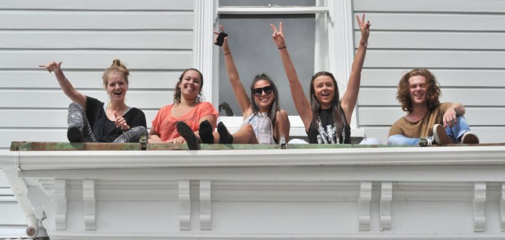 Flatmates (from left) Oli Allen (19), of Auckland, Bridget Abraham (25), of Auckland, Kerri Ann Jones (19), of Whakatane, Ellie Sinclair (19), of Palmerston North, and Jack Clarke (19), of Taupo, enjoy the sunshine outside their Cumberland St flat on Satu