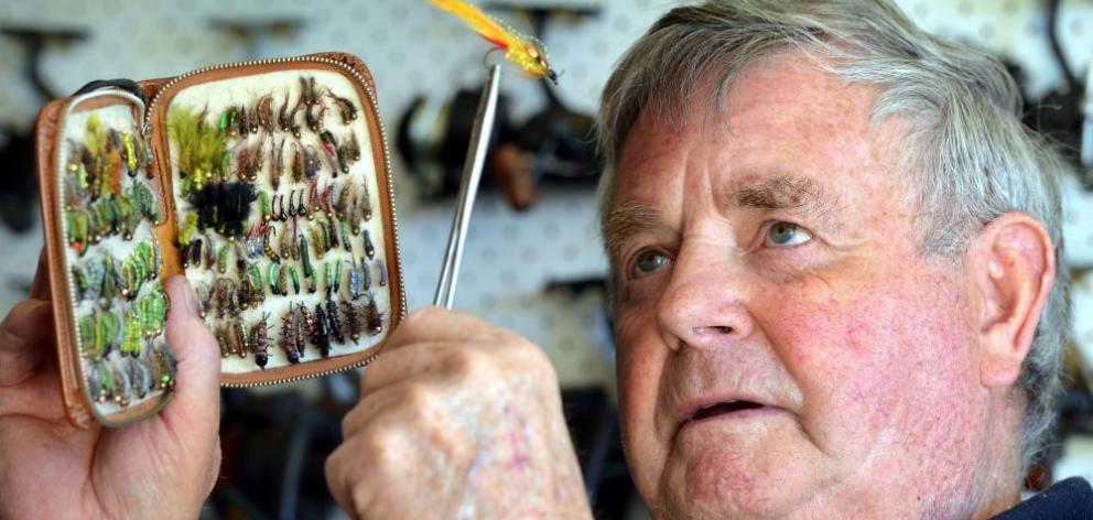 Jim Curline looks through some of his thousands of home-made flies in preparation for the fishing season opening today. Photo by Stephen Jaquiery.