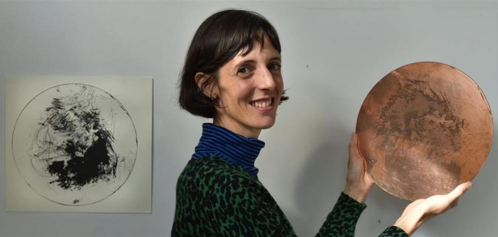 New Zealand-born artist Kate Davis shows the copper plate she used to create the etching On Sensitive Ground (left). PHOTO: GREGOR RICHARDSON